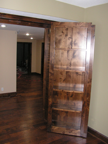 Bookcase that is hinged from inside the room